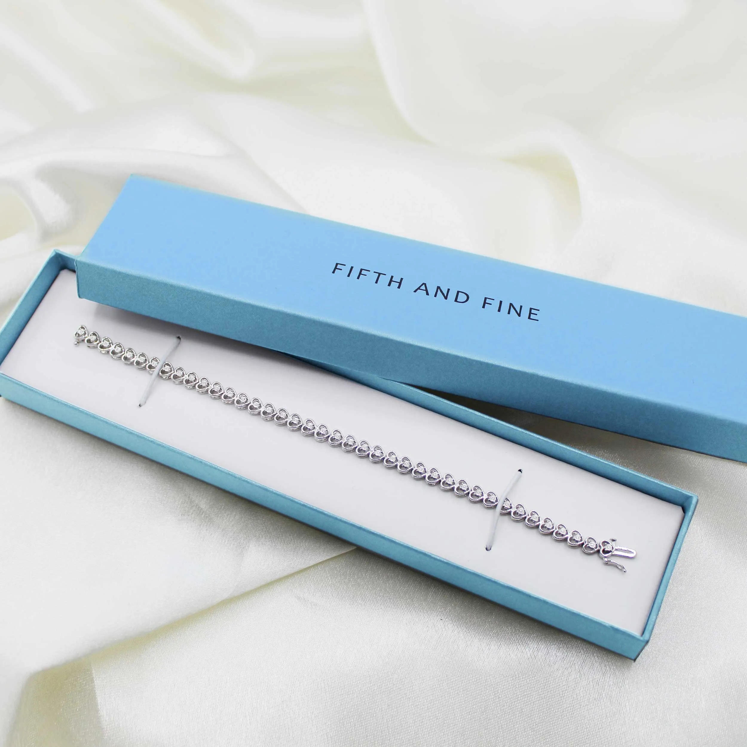1/8ct tw Diamond Infinity Heart Tennis Bracelet in Sterling Silver